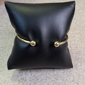 Bracelet gold tone with two beads.